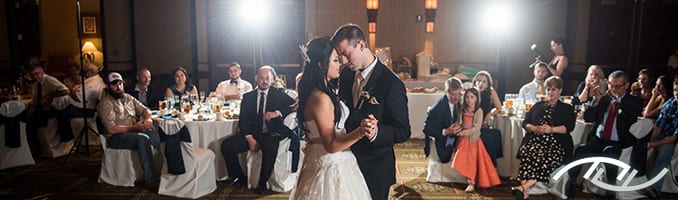 Jordan & Michaela share their First Dance as their Friends and Family watch at the Capital Plaza Hotel in Topeka, KS. Peter Merry with MERRY WEDDINGS was their Wedding Entertainment Director®. (Photo Credit: Melissa Sigler Photography)