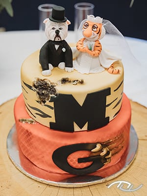 John & Cheri's groom's cake featuring their favorite college teams, the Mizzou Tigers and the Georgia Bulldogs at the Stover Community Center in Stover, MO. (Photo Credit: Amber Koelling Photography)