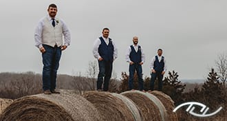 John and his Groomsmen standing on Hay Bales in Florence, MO. (Photo Credit: Amber Koelling Photography)