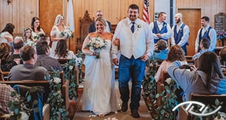 John & Cheri walking back down the aisle together as Newlyweds in the Mt. Olive Baptist Church in Florence, MO. (Photo Credit: Amber Koelling Photography)