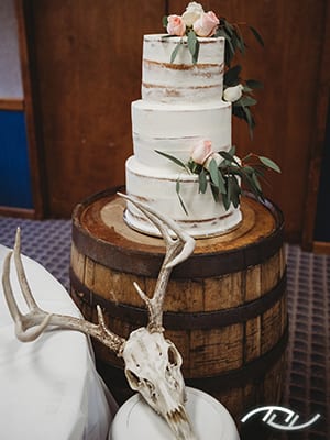 John & Cheri's naked cake with antlers at the Stover Community Center in Stover, MO. (Photo Credit: Amber Koelling Photography)